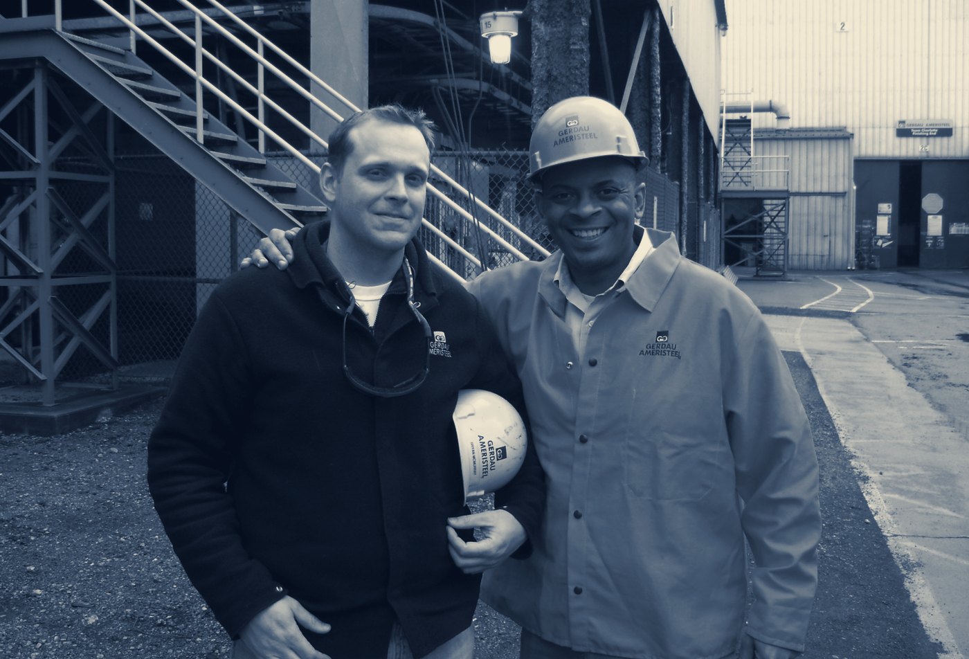 Bryan McMurray on the production floor at Gerdau Ameristeel in Charlotte, standing with then-mayor Anthony Foxx